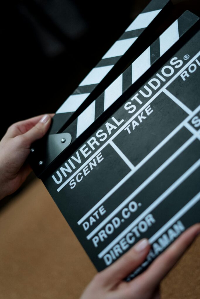 A detailed view of a Universal Studios clapboard held in hands, perfect for film industry concepts.